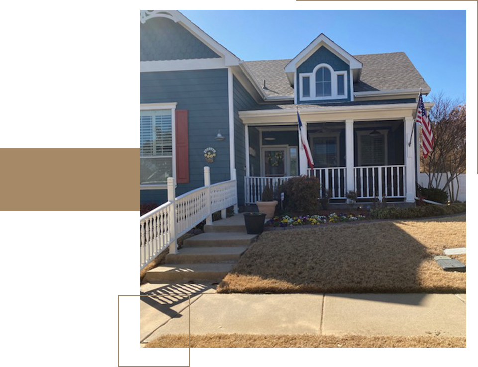 A blue house with white trim and a flag.